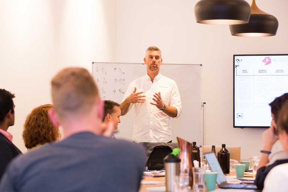 Mark Dobson presenting to room of business people