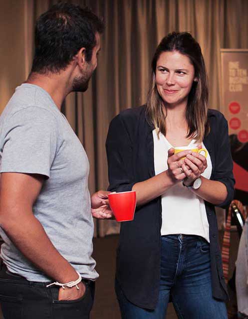 Two people sharing ideas at goals event