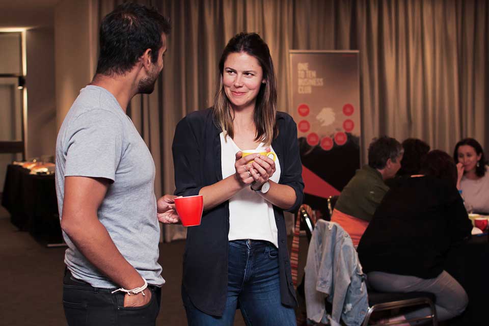 Two people sharing ideas at business strategy event