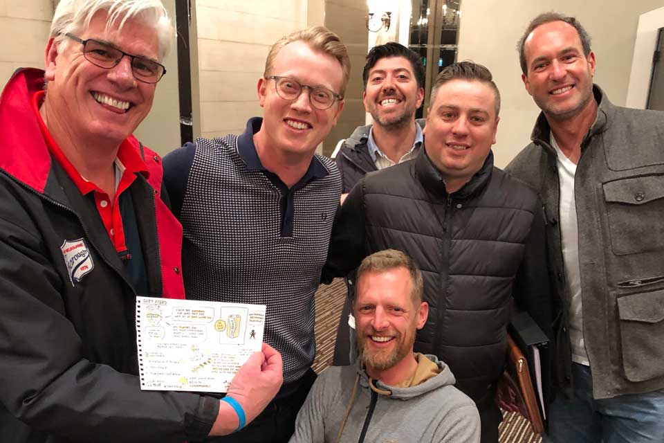 Gary receiving Sketch artist mind map at Mark's Business Club event